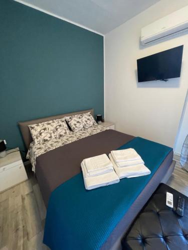 a bedroom with a bed with two towels on it at La Tanchetta in Alghero