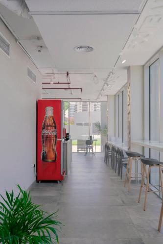 a room with chairs and a soda bottle on a red door at Emirates Sports Hotel, Dubai Sports City in Dubai