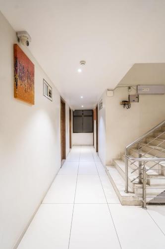 an empty room with a staircase in a building at Hotel Bhabha in Rajkot