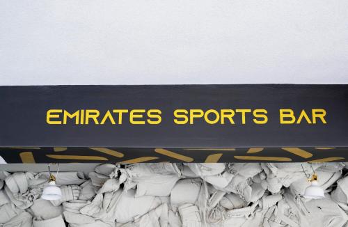 a sign for an emirates sports bar hanging on a wall at Emirates Sports Hotel, Dubai Sports City in Dubai