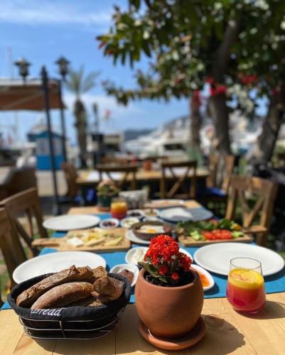 a table with plates of food on top of it at Gocek Unlu Hotel in Göcek