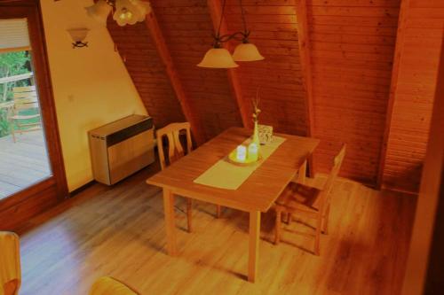 a dining room with a wooden table with chairs at Ferienhaus Lüttje Swaan in Detern