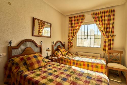 a bedroom with two beds and a window at Espanhouse Villa in Ciudad Quesada for 4 in Ciudad Quesada