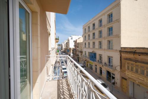 a balcony with a view of a city street at Vela Blu Boutique Suites in Il-Gżira