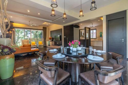 a dining room with a table and chairs at StayVista's Verde Villa with Private Pool, Games Room & Terrace in Lonavala