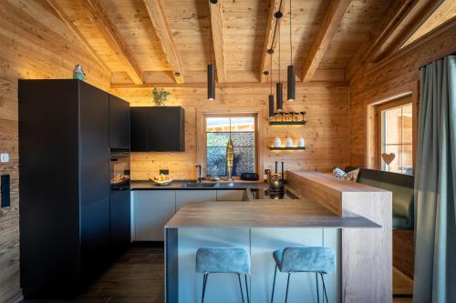 a kitchen with wooden walls and a wooden ceiling at Mountain Chalet R in Berwang