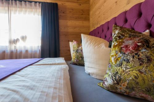 a bedroom with a bed with pillows and a window at Mountain Chalet R in Berwang