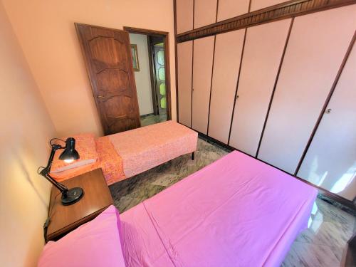 a small room with two beds and a mirror at Appartamento Pilloa in La Spezia
