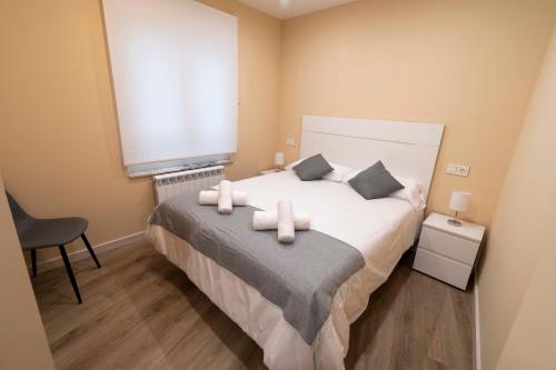 a bedroom with a bed with white towels on it at Espectacular piso en casco histórico-plaza Don Gutierre in León