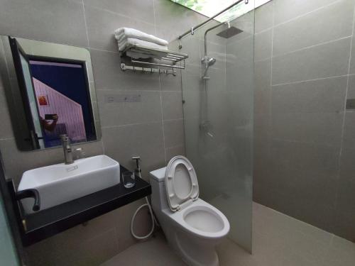 a bathroom with a toilet and a sink and a shower at Balaha in Dong Hoi