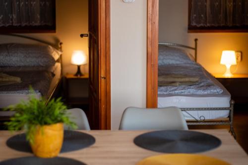 a room with a table and two bunk beds at Kotyogó Apartmanok, Bogács in Bogács