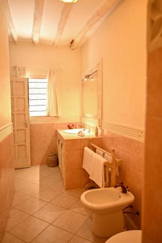 a bathroom with a toilet and a sink and a mirror at Lions' Luxury Eco Resort & Spa in Malindi