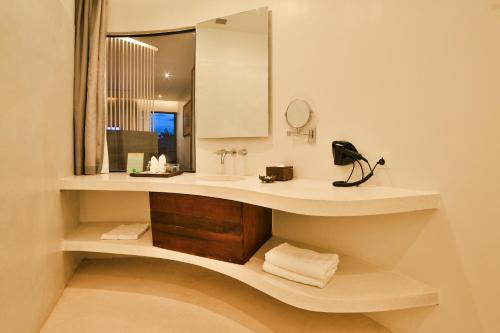 a bathroom with a sink and a mirror at The Villa by Metta in Siem Reap