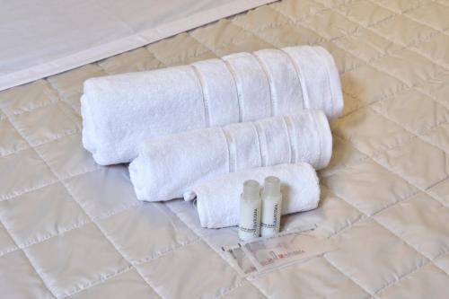 a group of towels and bottles on a bathroom floor at [CENTRO-LECCO] Romantico Appartamento sul Lago in Lecco