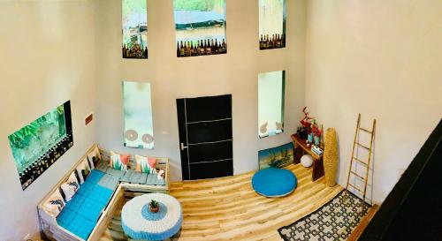 a living room with a couch and a tv at Hidden of Cailan Inn in El Nido
