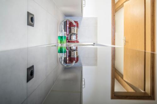 a glass light hanging from a wall in a bathroom at Apartments Heidenberger Delle Scuole in Colle Isarco