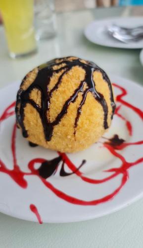 a dessert on a white plate with chocolate sauce at Venus Hotel in Pamukkale