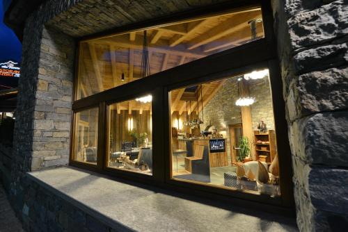 a window of a house with a living room at Hotel Maison Saint Jean in Courmayeur