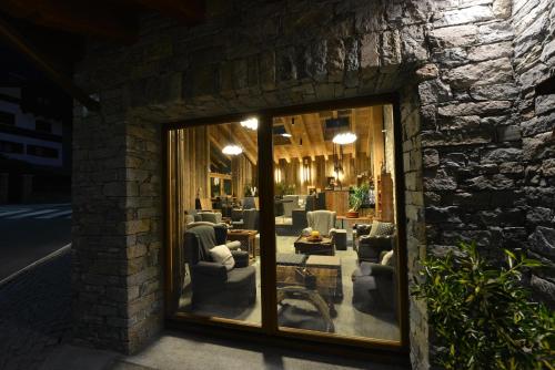 a building with a window with chairs in a room at Hotel Maison Saint Jean in Courmayeur
