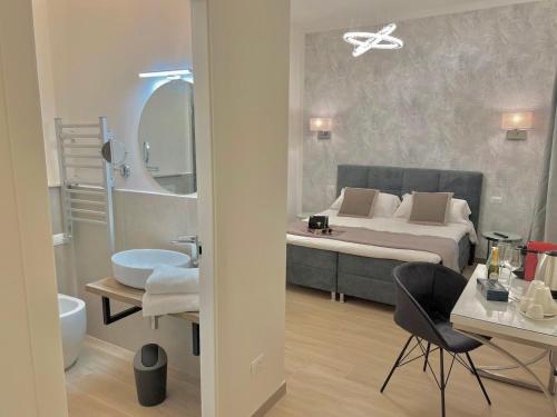 a bedroom with a large bed and a bathroom at Relais Roma Vaticano - METRO station Ottaviano in Rome