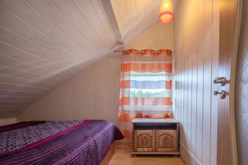 a small bedroom with a bed and a window at Tourist Apartment in Klaipėda