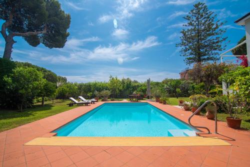 a swimming pool in a yard with a patio at Magnificent Villa Sanremo in Sanremo