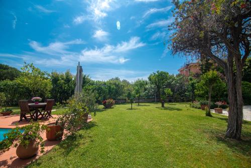a park with a bench and a picnic table at Magnificent Villa Sanremo in Sanremo