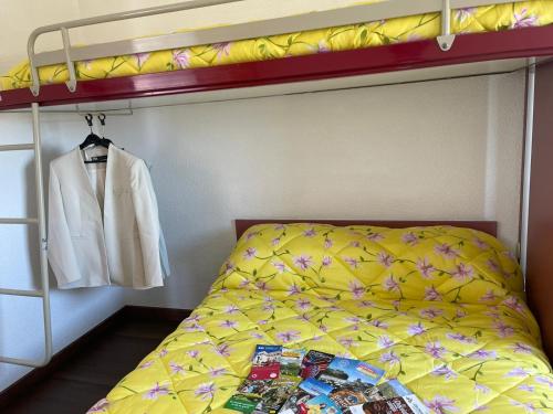 a bedroom with a bunk bed with a jacket and a shirt at HOTEL PARIS VALENCE in Bourg-de-Péage