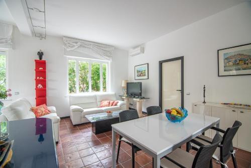 a living room with a white table and chairs at Magnificent Villa Sanremo in Sanremo