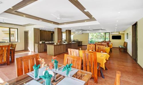 a dining room with a table and chairs at IKIGAI Green Valley Beach Resort in Dona Paula