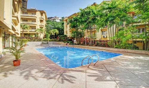 ein Schwimmbad in der Mitte eines Gebäudes in der Unterkunft IKIGAI Green Valley Beach Resort in Dona Paula