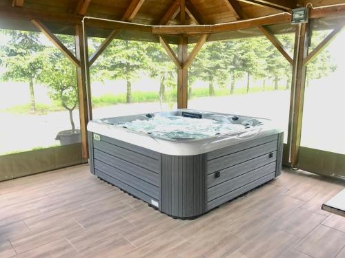 a hot tub in a gazebo at Mátyás Vendégház 3 Rooms Apartment in Kópháza