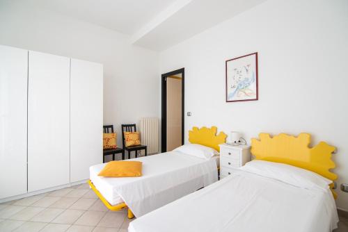 two beds in a room with white walls at Magnificent Villa Sanremo in Sanremo