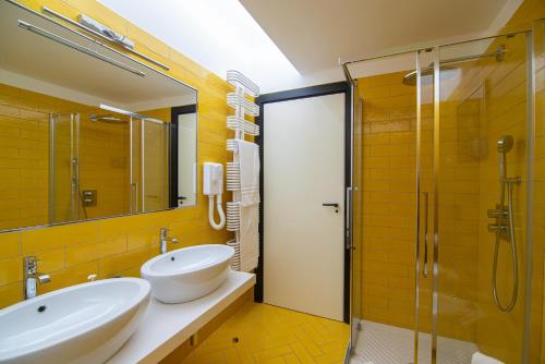 a bathroom with two sinks and a glass shower at Magnificent Villa Sanremo in Sanremo