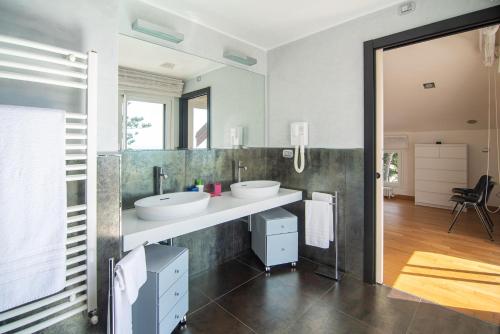 a bathroom with two sinks and a large mirror at Magnificent Villa Sanremo in Sanremo