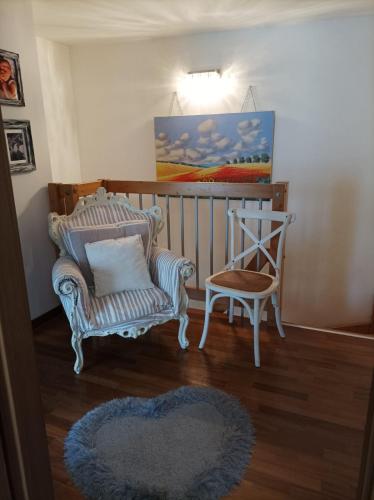 a living room with a chair and a pillow and a rug at La casa di Annalisa in Ortona