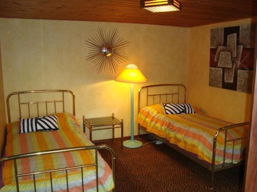 a bedroom with two beds and a lamp in it at 2 room apartment in Ystad