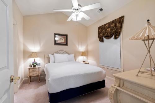 a bedroom with a white bed and a ceiling fan at Stunning 3BR Condo near Myrtlewood Golf Resort and Beach in Myrtle Beach