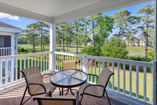 a patio with a table and chairs on a porch at Stunning 3BR Condo near Myrtlewood Golf Resort and Beach in Myrtle Beach