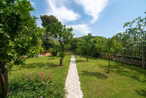 a path through a garden with trees and flowers at Magnificent Villa Sanremo in Sanremo