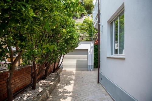 a walkway leading to a garage with a door at Magnificent Villa Sanremo in Sanremo