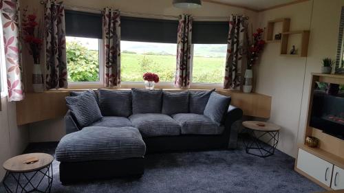 a living room with a couch and a window at Mountain View in Millom