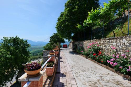 a stone walkway with potted plants on a wall at Saranda Landscape in Nivicë