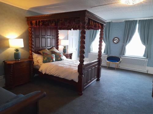 a bedroom with a canopy bed in a room at Stone Court House in Maidstone