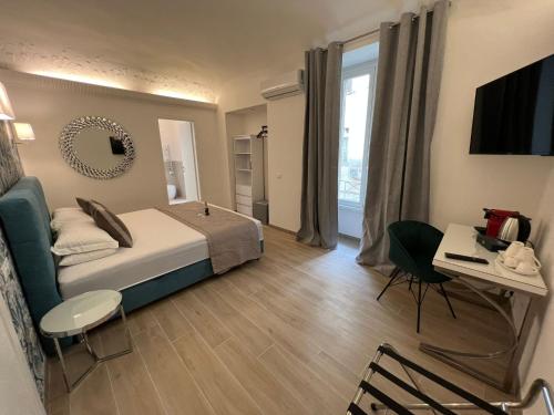 a bedroom with a bed and a table and a desk at Relais Roma Vaticano - METRO station Ottaviano in Rome