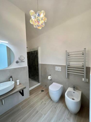 a bathroom with a sink and a toilet and a mirror at Relais Roma Vaticano - METRO station Ottaviano in Rome