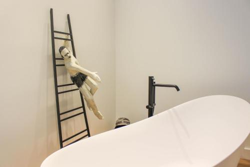 a wooden skeleton on a ladder next to a table at Valsabbion Deluxe City Suite in Pula