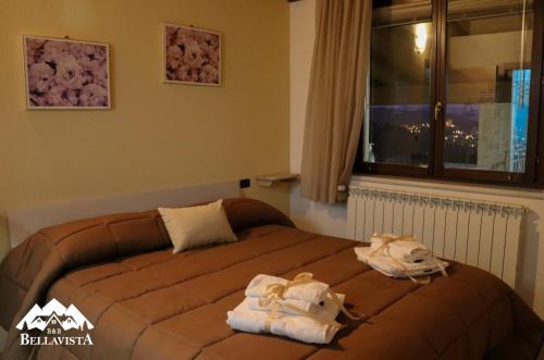 a bedroom with a bed with towels on it at B&B Bellavista in Celano