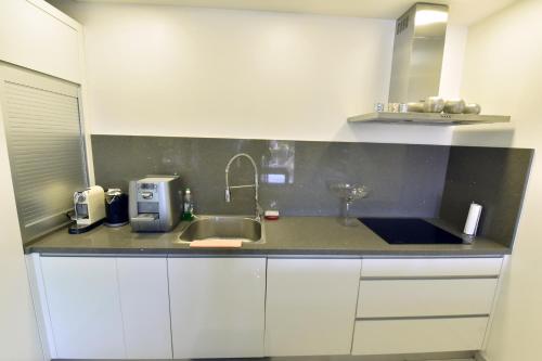 a kitchen with a sink and a counter top at Royal Park Eilat apartments in Eilat
