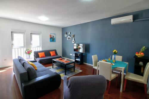 a living room with a couch and a table at Bonki apartment private free parking in Mokošica